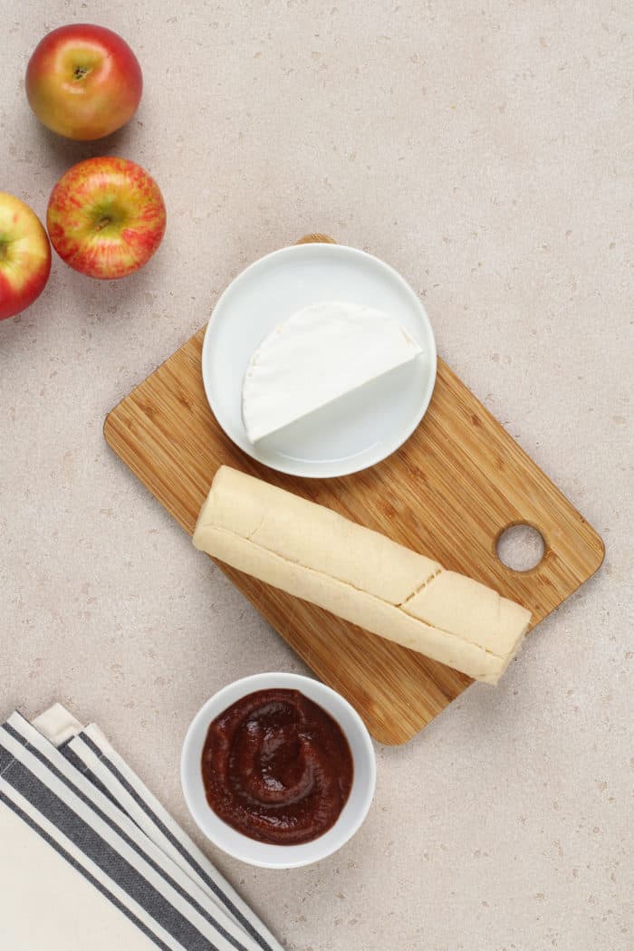 Ingredients for apple butter brie bites arranged on a countertop.