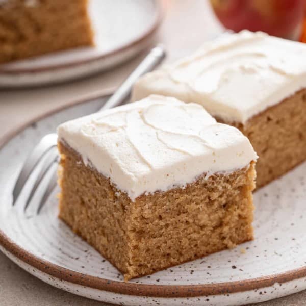 Two slices of apple butter cake on a stoneware plate.