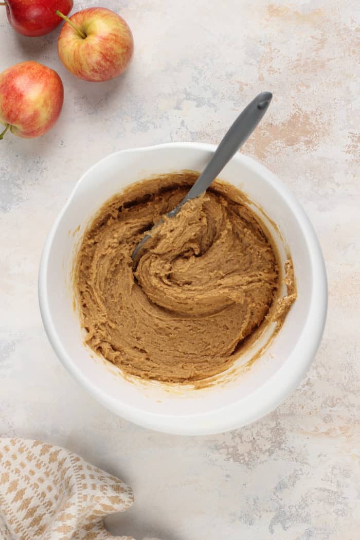 Batter for apple cider blondies in a white mixing bowl.