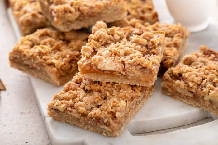 Apple crisp bars scattered in a marble platter.