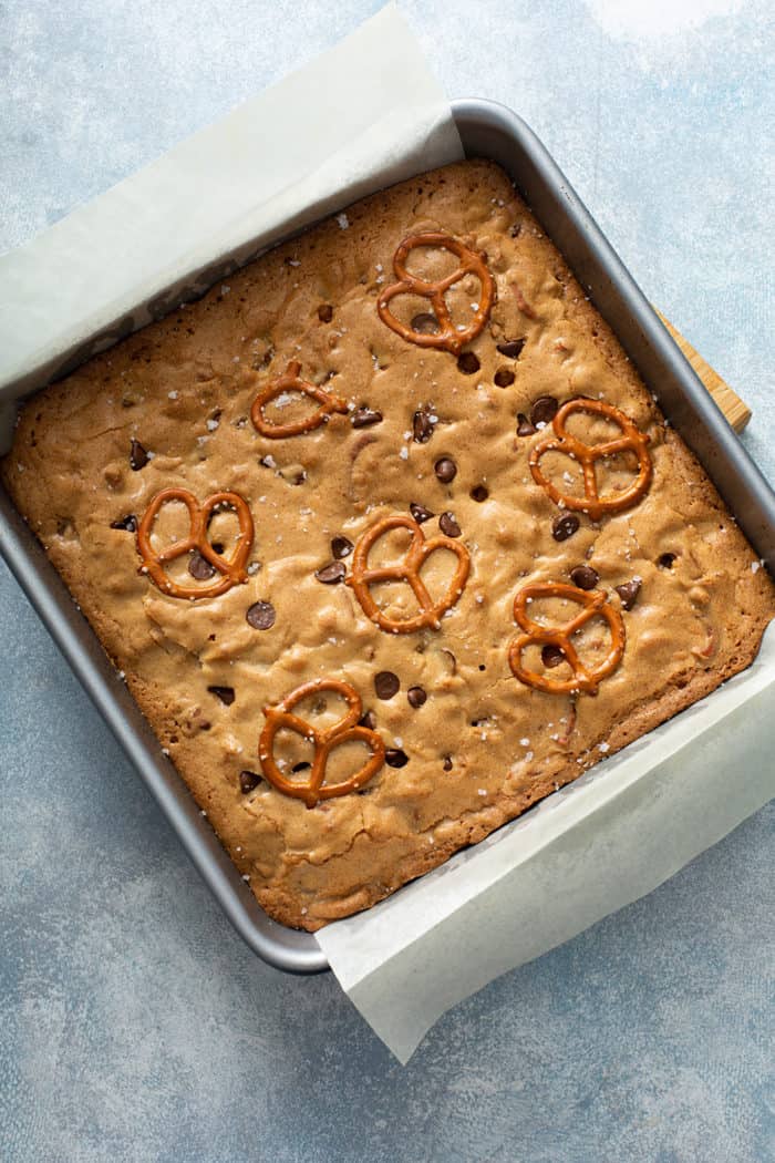 Baked salted caramel blondies with pretzels in a metal baking pan