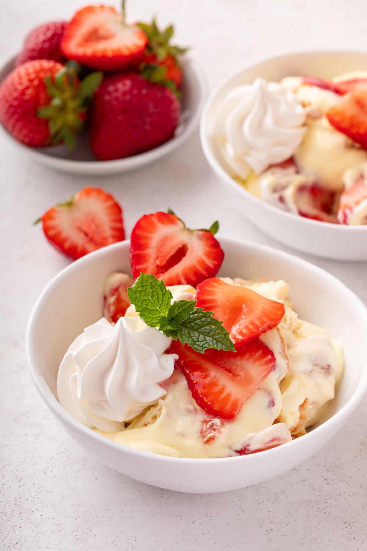 Serving of strawberry trifle in a white bowl.