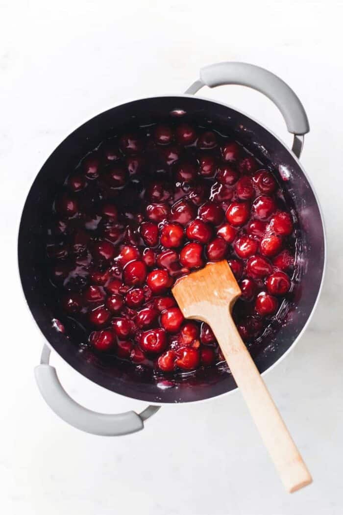 Pot of cherries reducing for cherry pie filling