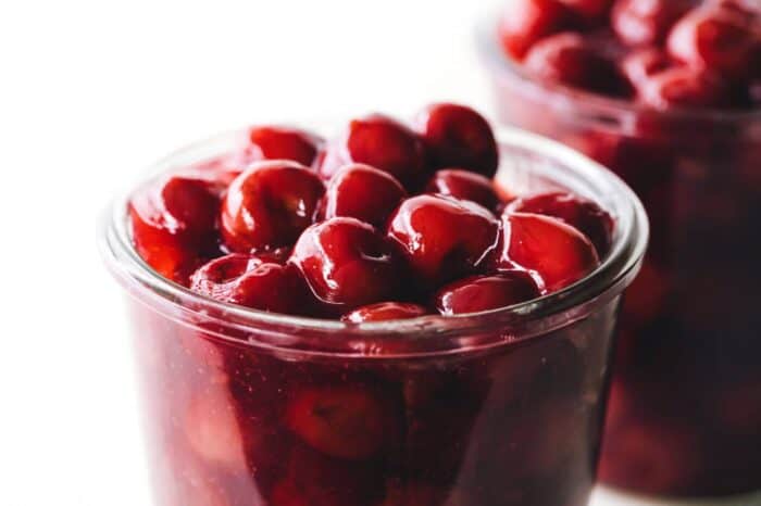 Close up of a glass jar of cherry pie filling