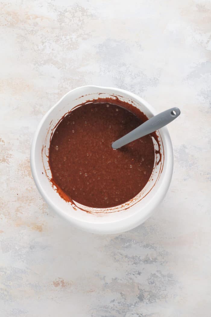 Chocolate bread batter in a white bowl.