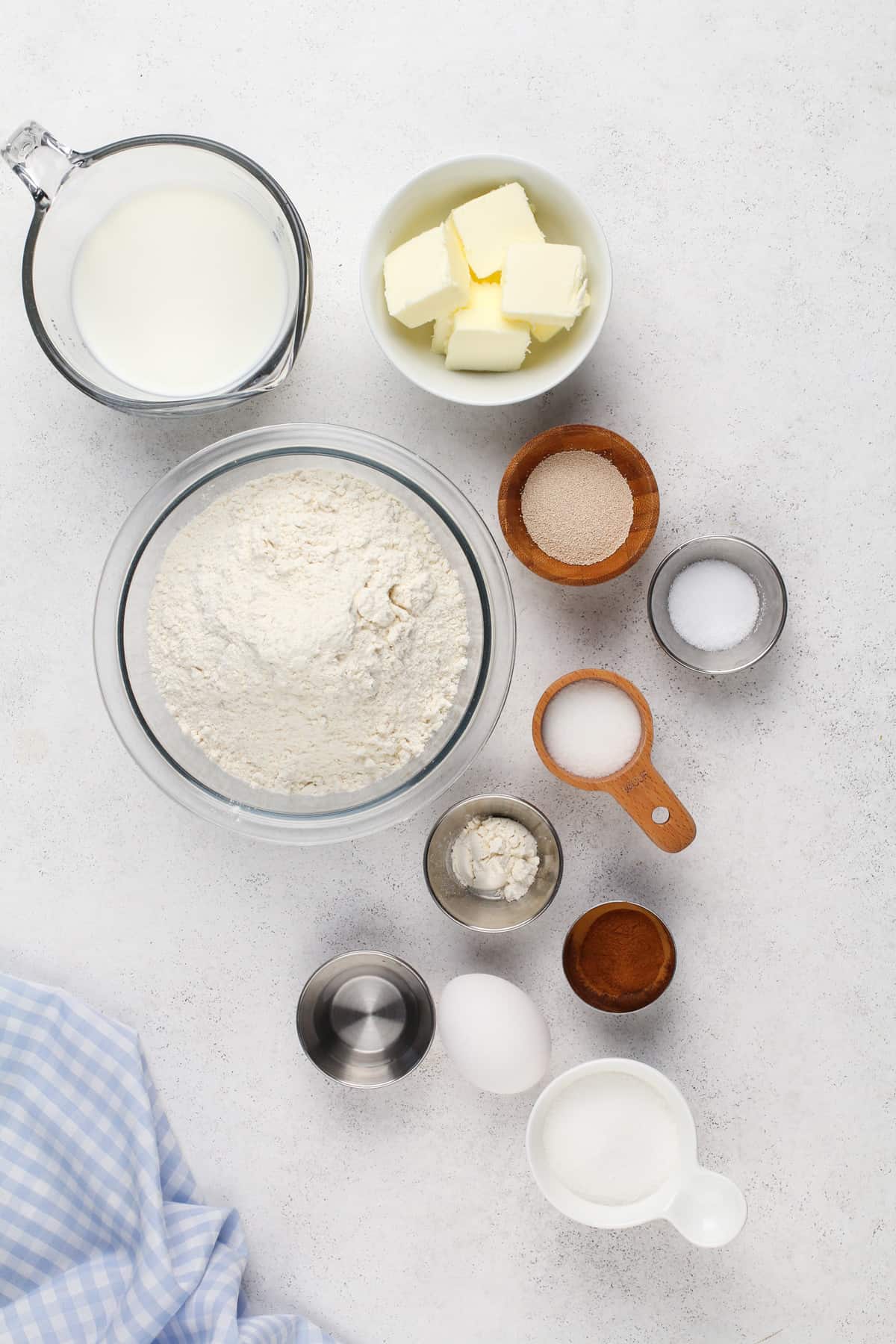 Ingredients for cinnamon swirl bread on a white countertop.