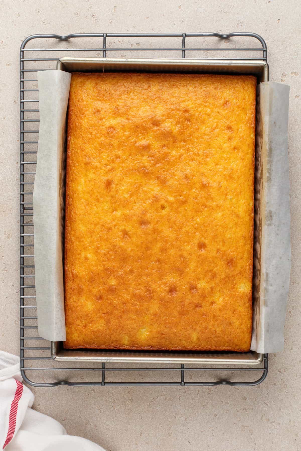 Baked easy pineapple cake cooling on a wire rack.