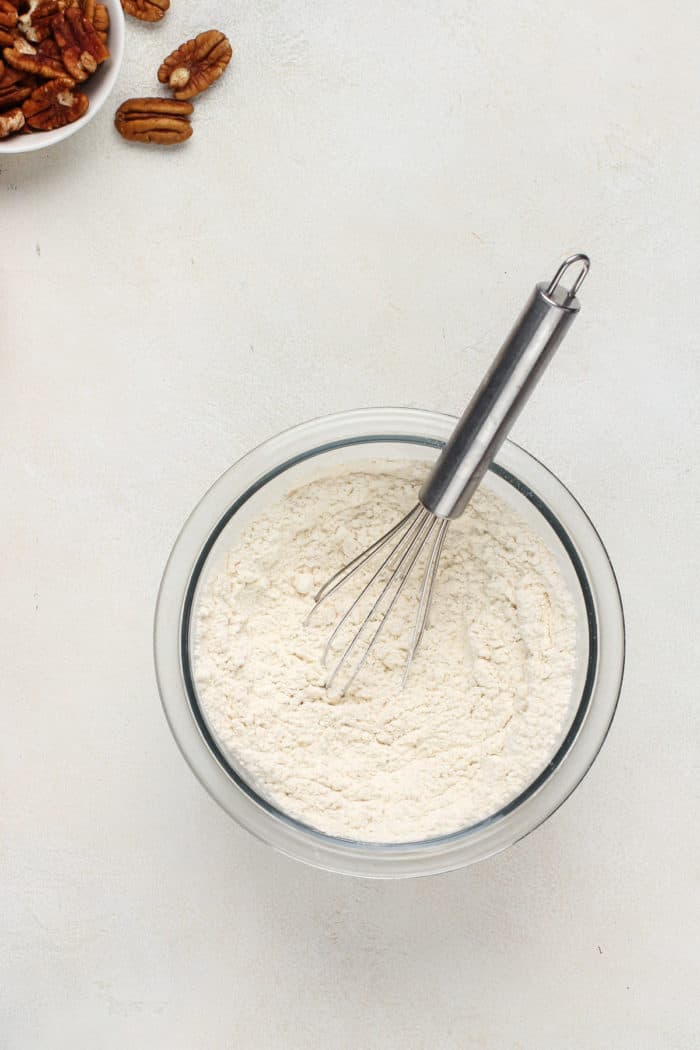 Dry ingredients for white chocolate blondies in a glass bowl.