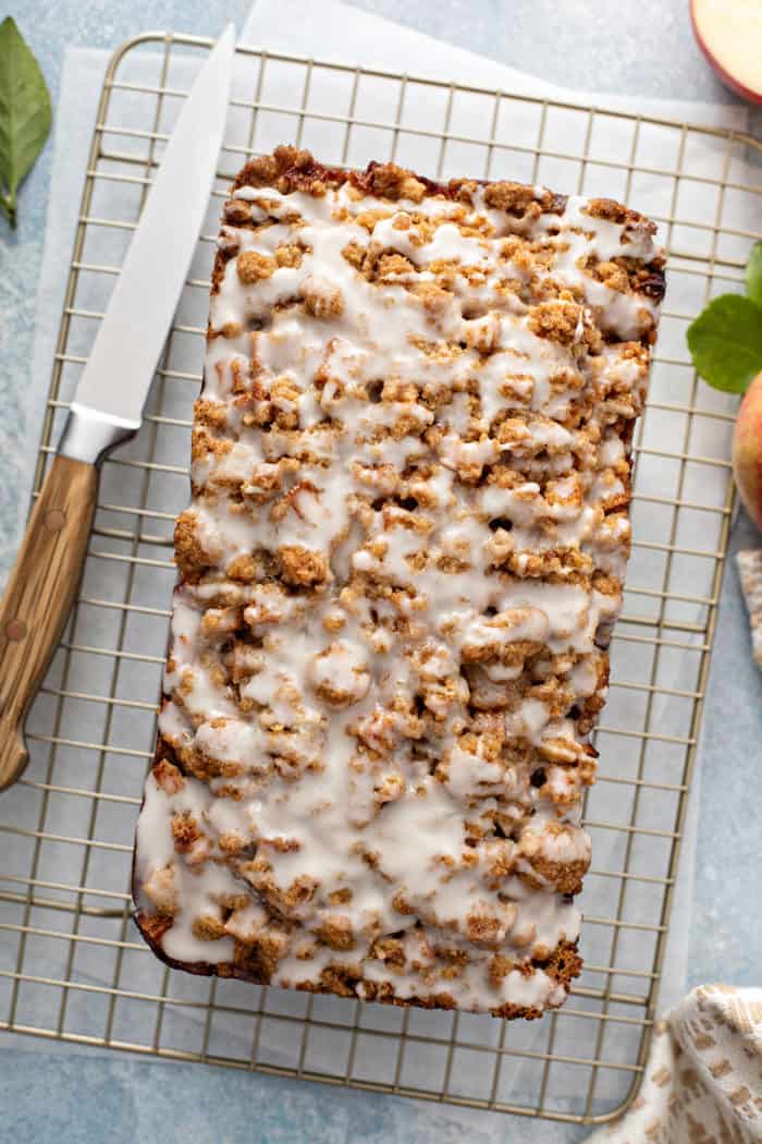 Overhead view of glazed apple fritter bread set on a wire rack