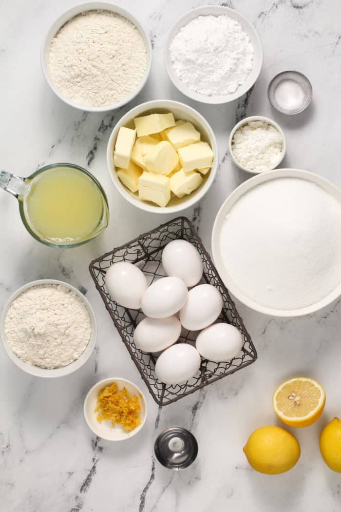 Lemon bar ingredients arranged on a marble countertop.