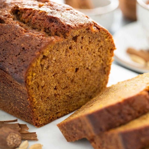 Sliced loaf of butternut squash bread on a cutting board