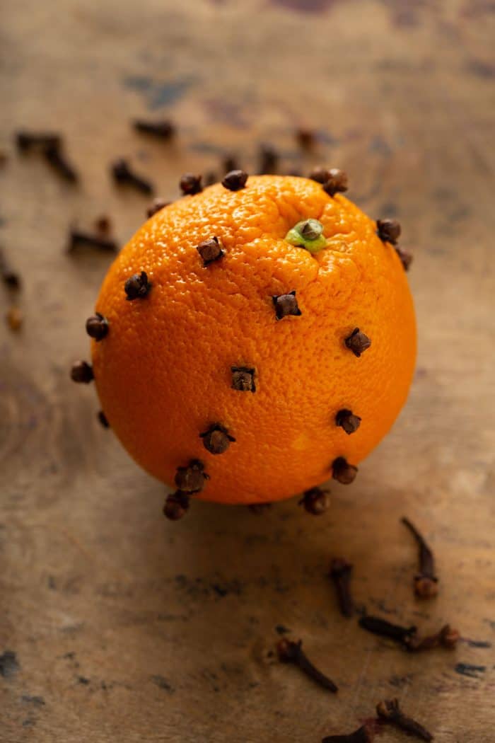 Orange studded with cloves on a countertop