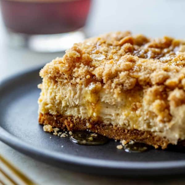 Close-up side view of a sliced maple streusel cheesecake bar