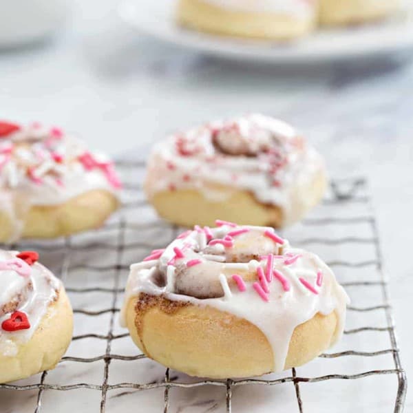 Mini Cinnamon Rolls are a fun and delicious way to celebrate any holiday! A sweet glaze and colorful sprinkles make them extra festive.