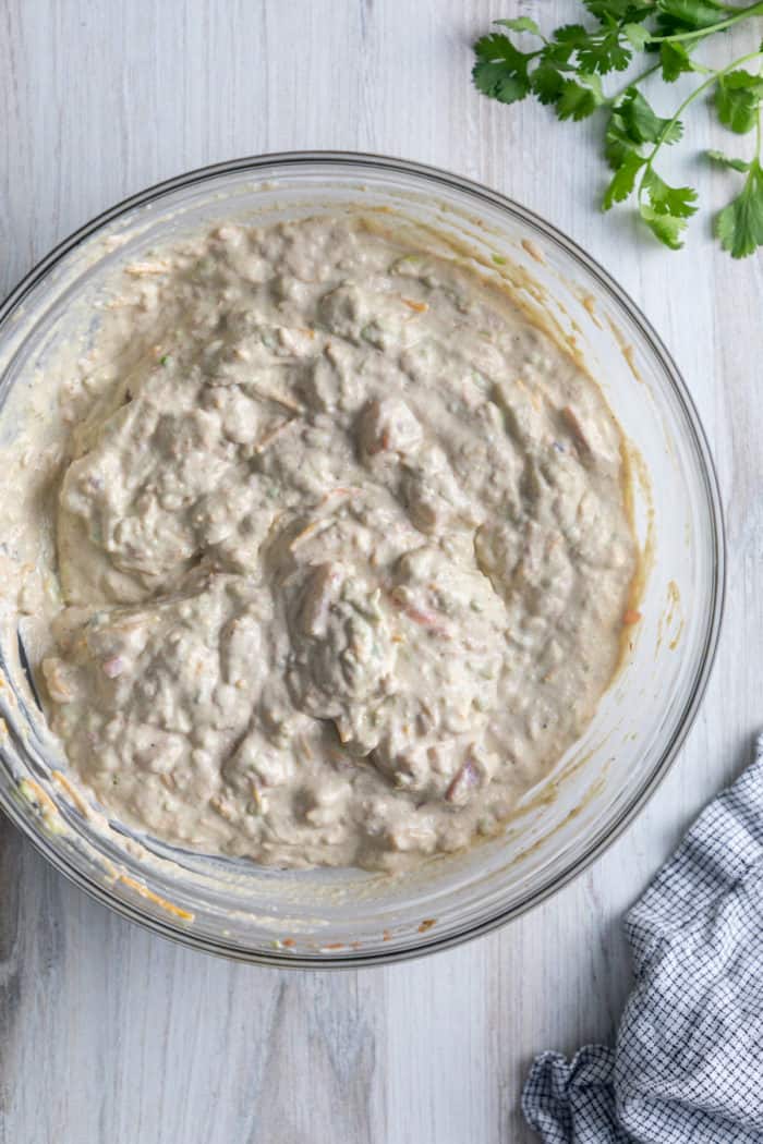 Mixed avocado dip in a glass bowl.