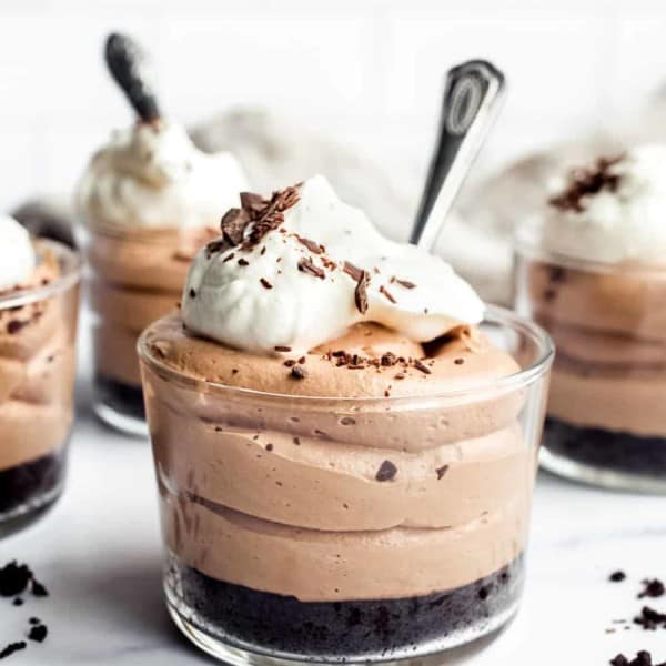 Close up of mini no bake nutella cheesecake with oreo crust in a glass ramekin