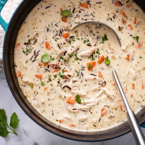 Overhead view of chicken and wild rice soup in a large dutch oven.