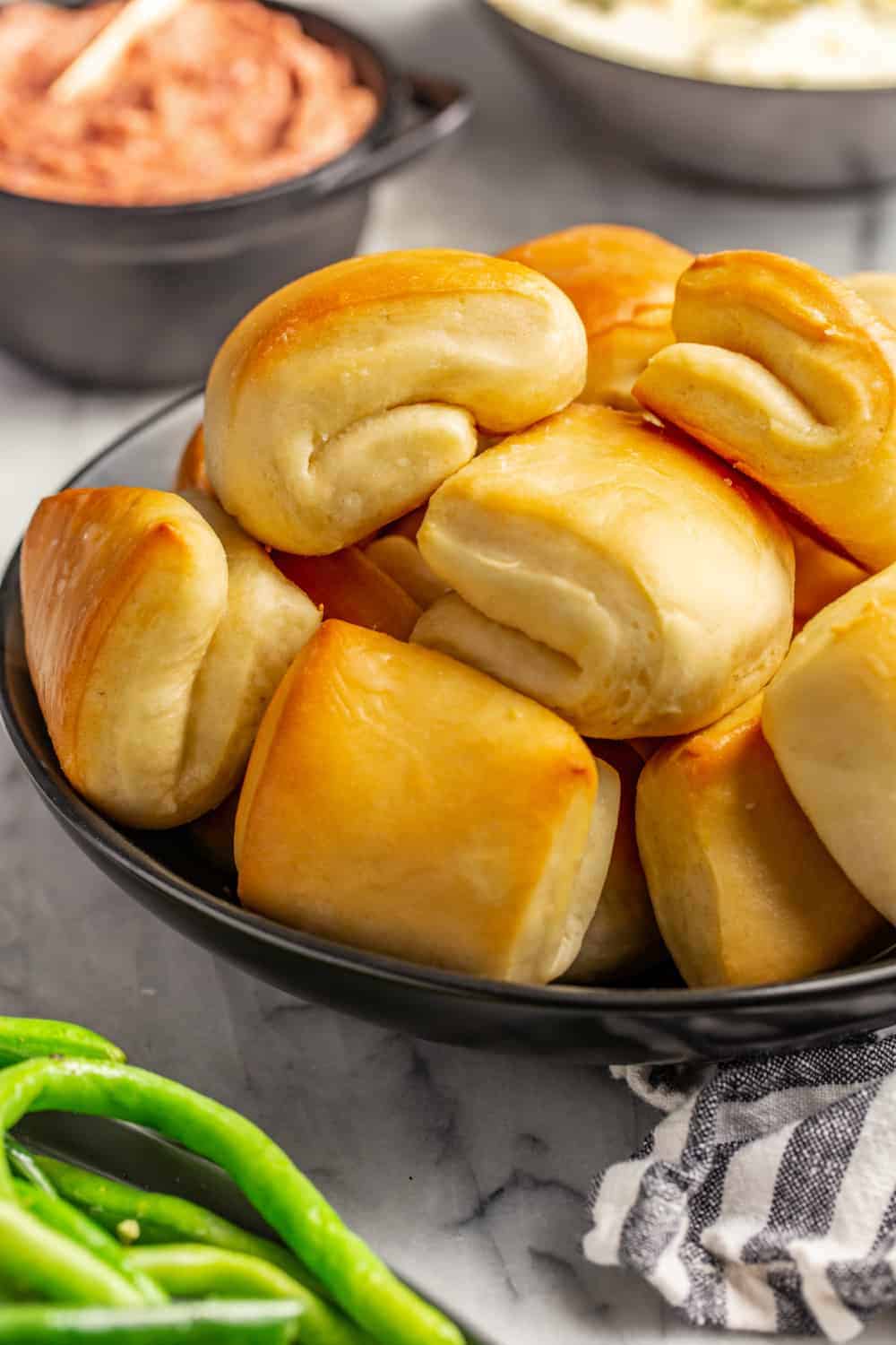 Close up of baked parker house rolls, showing the folded shape