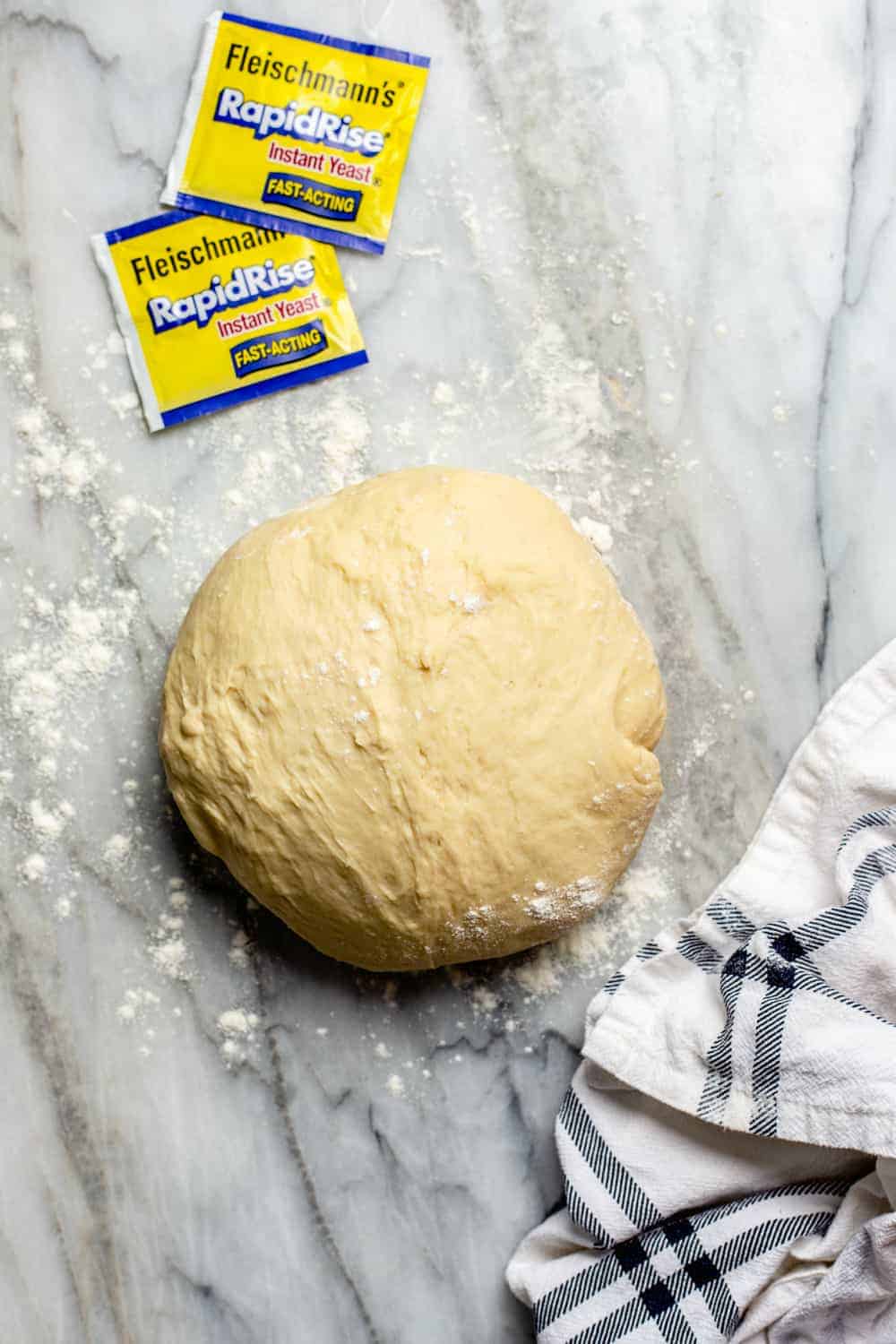 Dough for parker house rolls on a marble surface