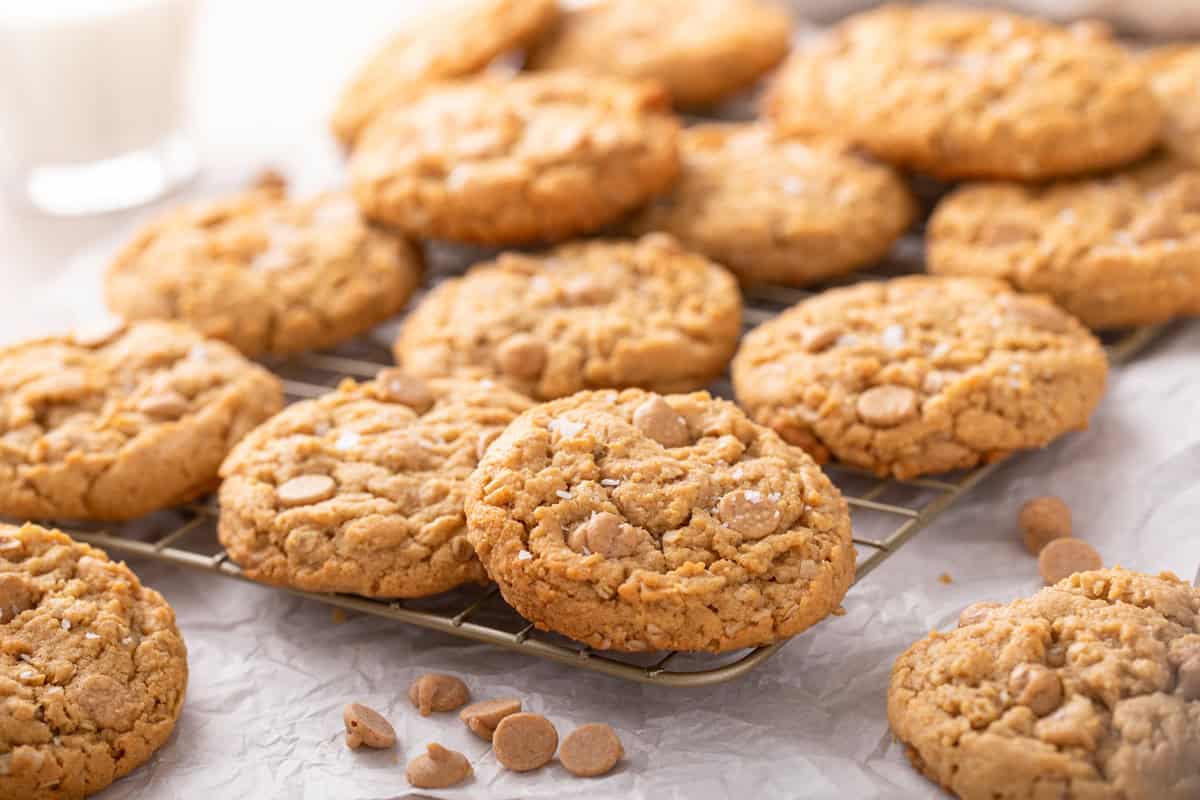 Peanut butter oatmeal cookies arranged on a wire rack.