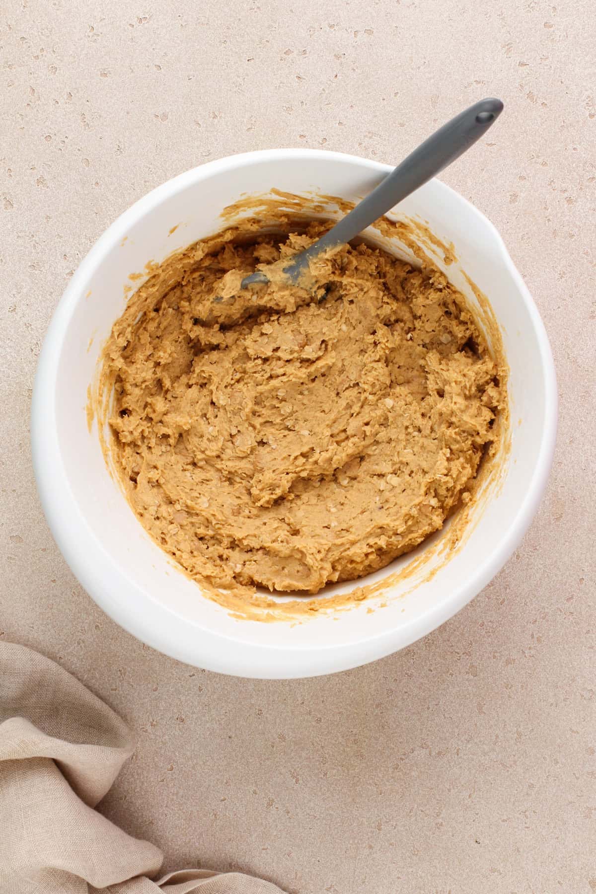 Peanut butter oatmeal cookie dough mixed in a white bowl.