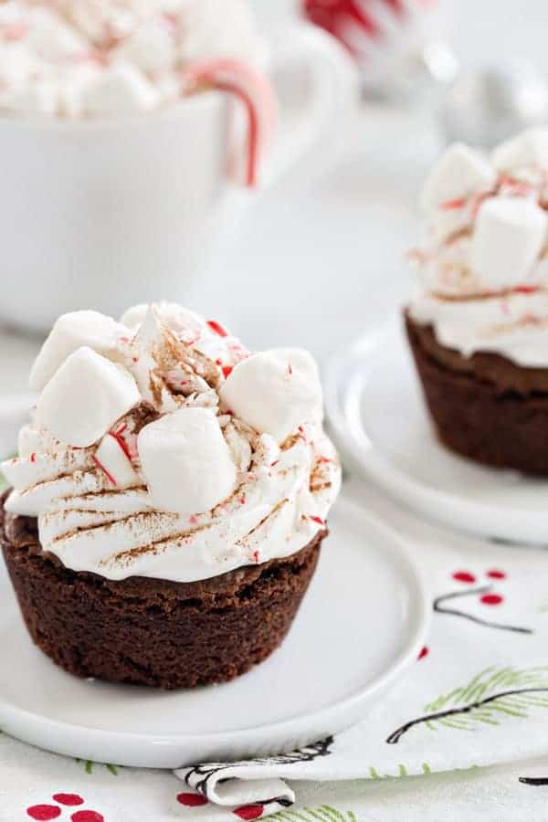 Peppermint Cocoa Brownie Cups are a simple and delicious way to celebrate the season. Mini marshmallows and crushed candy canes make them a dessert the entire family will love