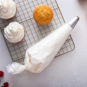 Piping bag filled with whipped cream frosting.