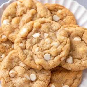 close up of white chocolate macadamia nut cookies on a plate.