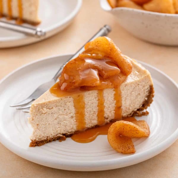 Plated slice of caramel apple cheesecake next to a fork.