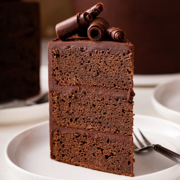 Slice of chocolate guinness cake on a white plate.