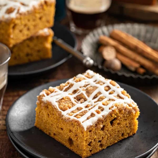 Piece of pumpkin coffee cake on a black plate