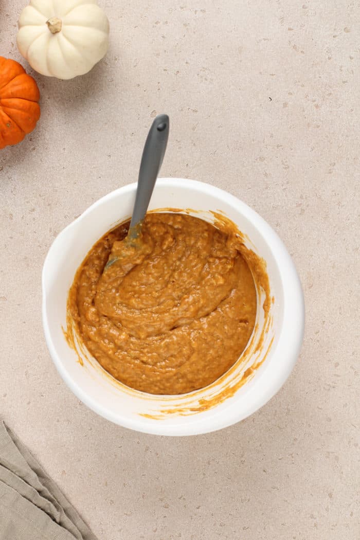 Pumpkin banana bread batter in a white mixing bowl.