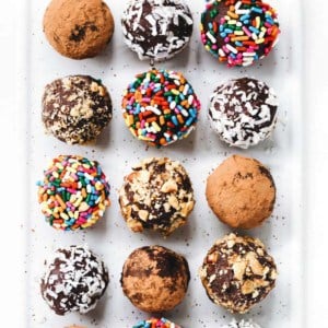 Overhead shot of homemade truffles in a variety of toppings on a plate