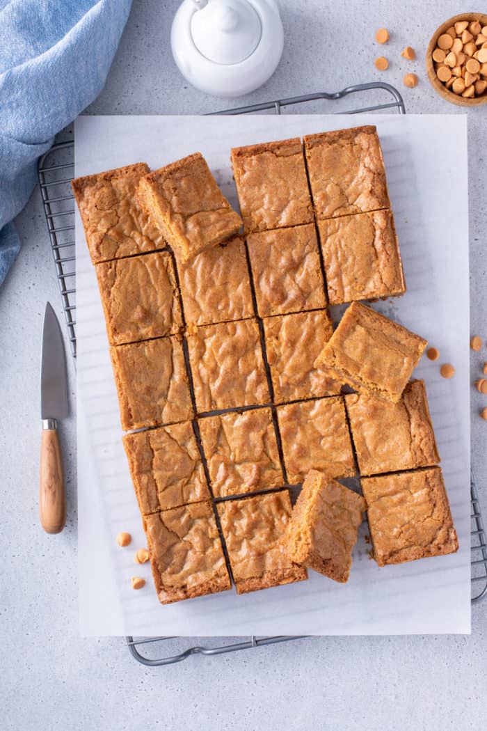 Overhead view of sliced brown butter blondies on a wire cooling rack.