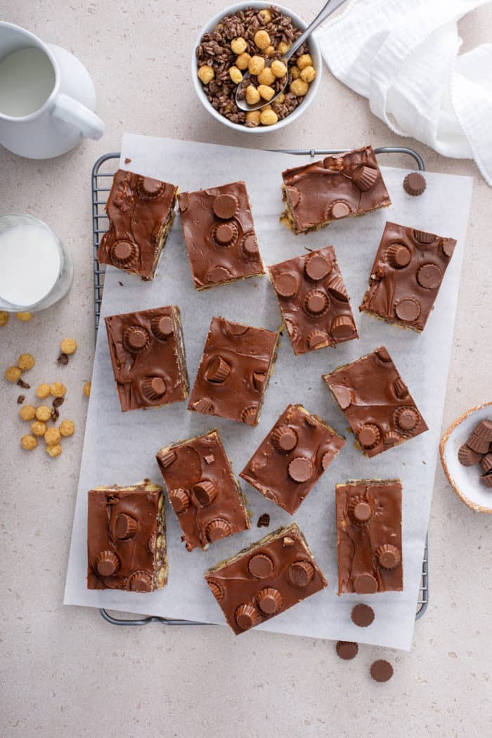 Overhead view of sliced peanut butter cup rice krispie treats on a piece of parchment paper.