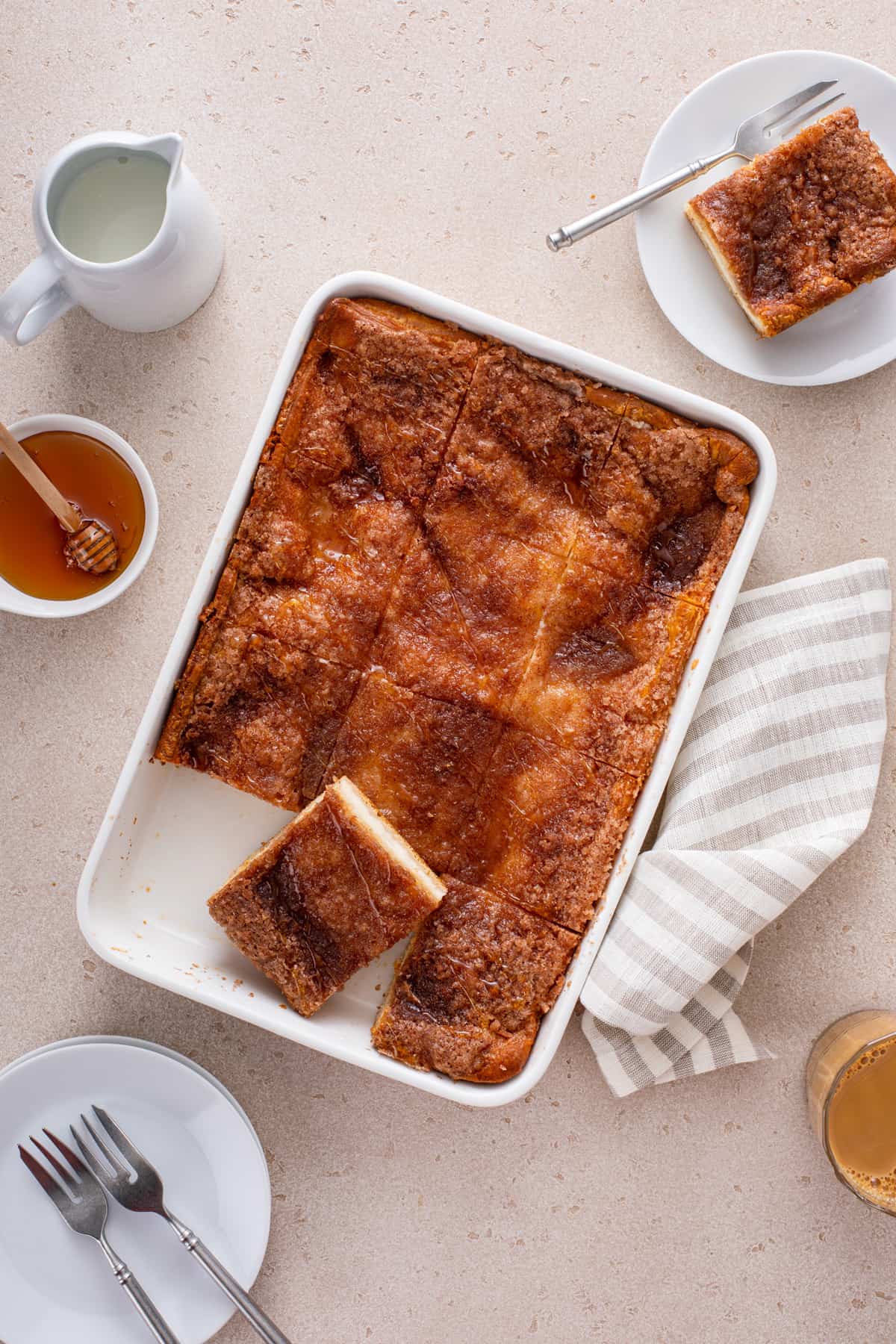 Sliced sopapilla cheesecake in a white baking dish.