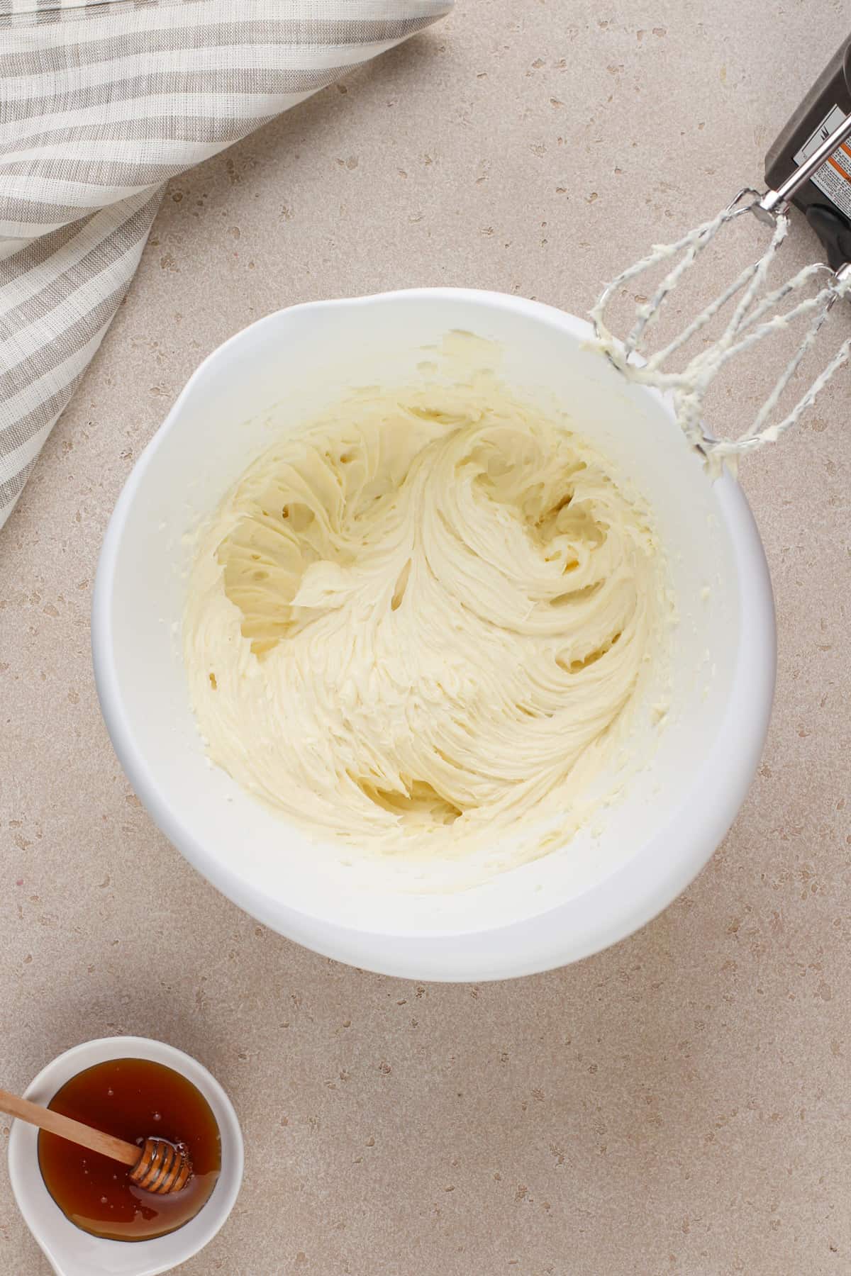 Filling for sopapilla cheesecake mixed in a white bowl.