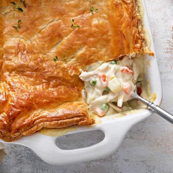 Assembled chicken pot pie casserole in a white baking dish, ready to go in the oven