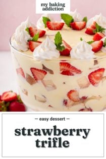 Close up of strawberry trifle layered in a trifle dish. Text overlay includes recipe name.