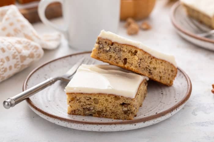 Two banana bars on a stoneware plate. One of the bars is propped up against the other.