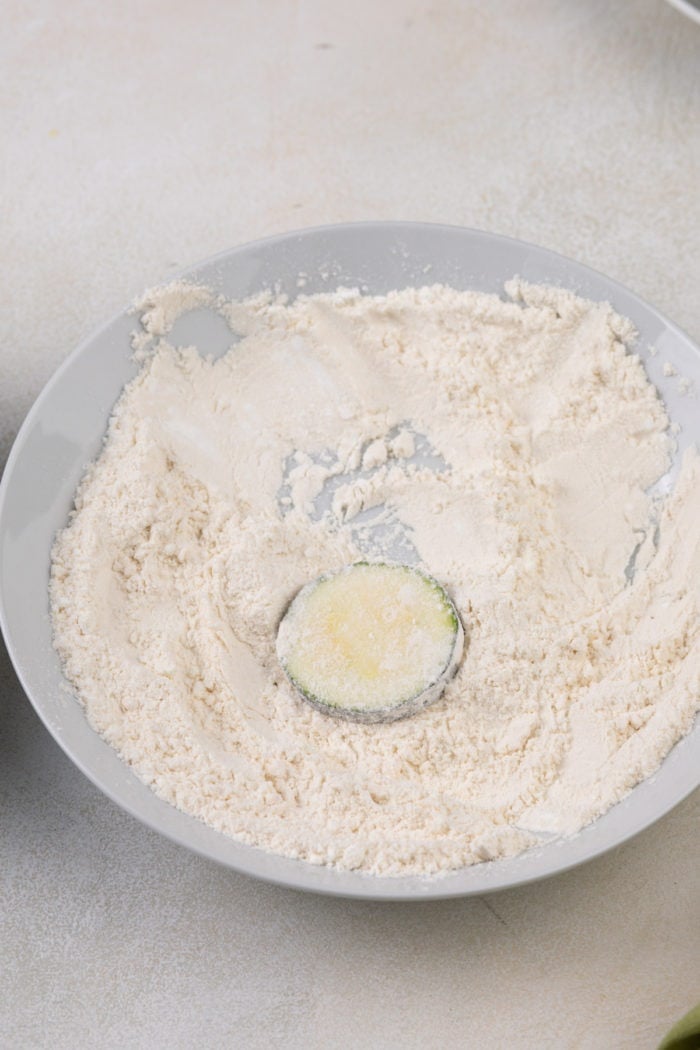 Zucchini round dredged in flour.